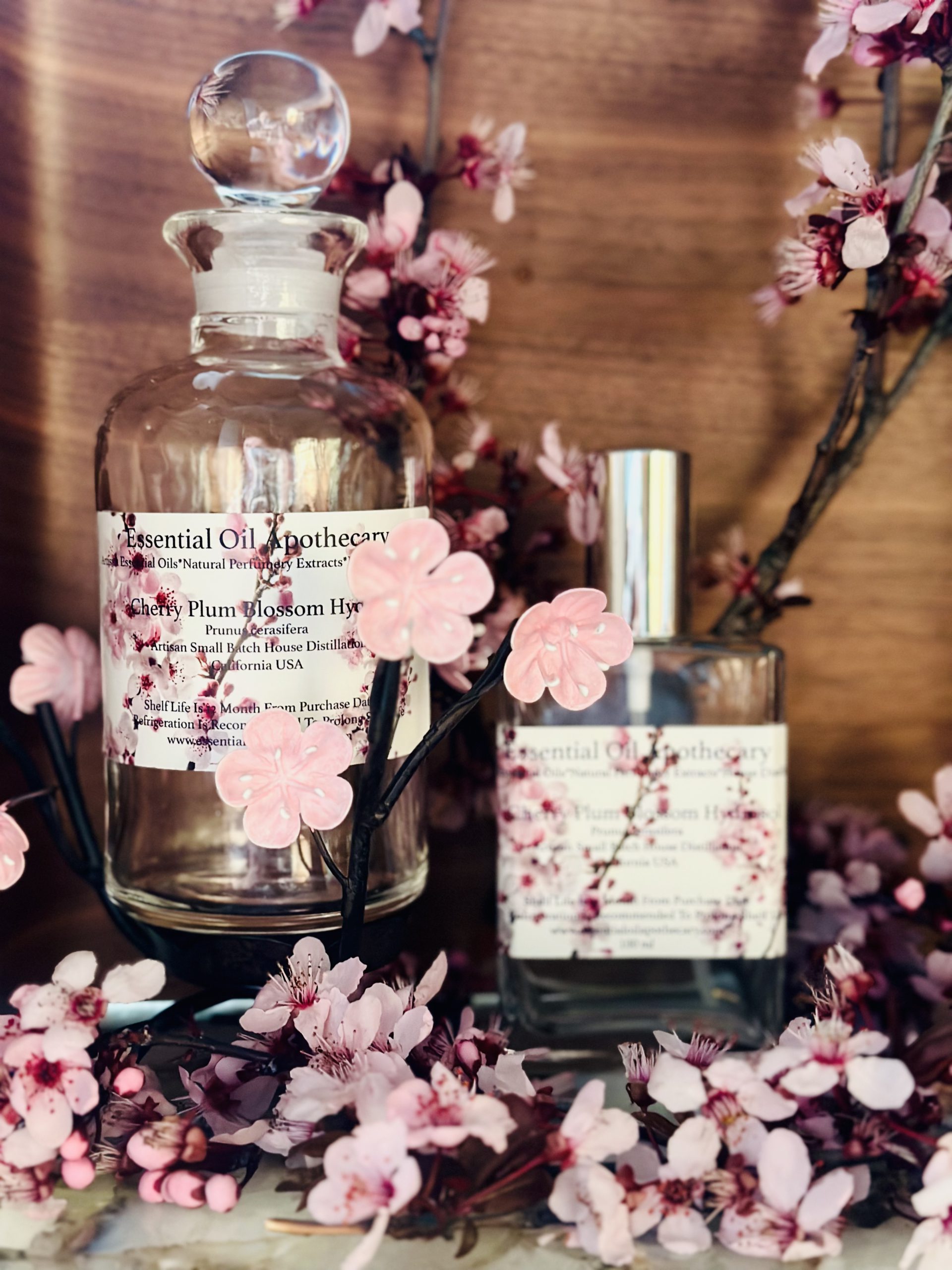 Bottles of essential oil with pink cherry blossoms Stock Photo by  ©MadeleineSteinbach 193115924